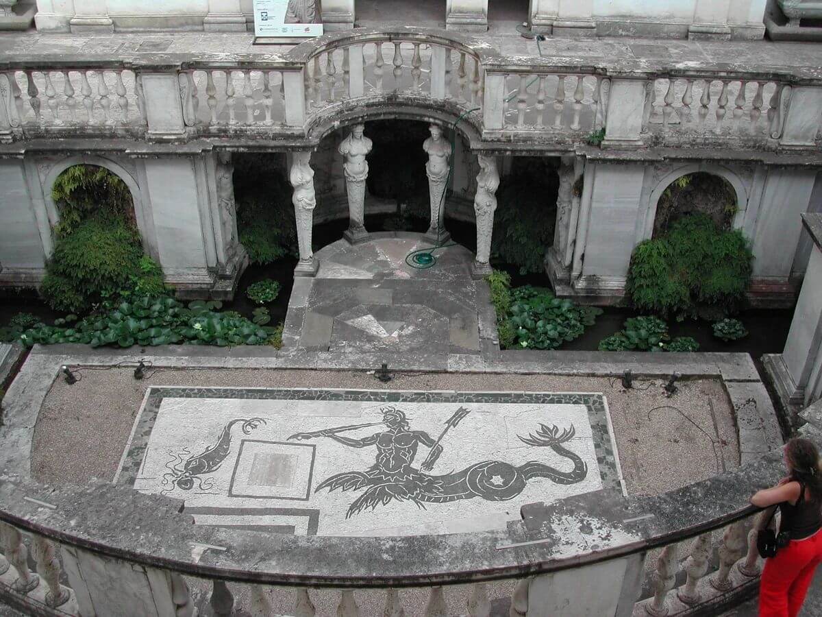 Historical view into Villa Giulia's sunken nymphaeum, showing its mosaic floor and supporting figures