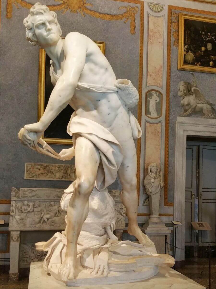 Bernini's marble David statue mid-throw at Galleria Borghese museum in Rome