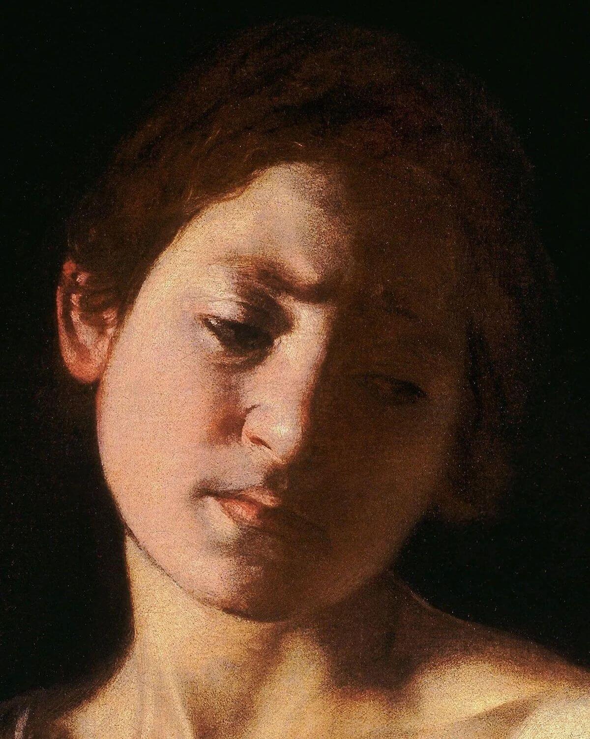 Detail of David’s tilted face and downcast gaze in Caravaggio’s David with the Head of Goliath.
