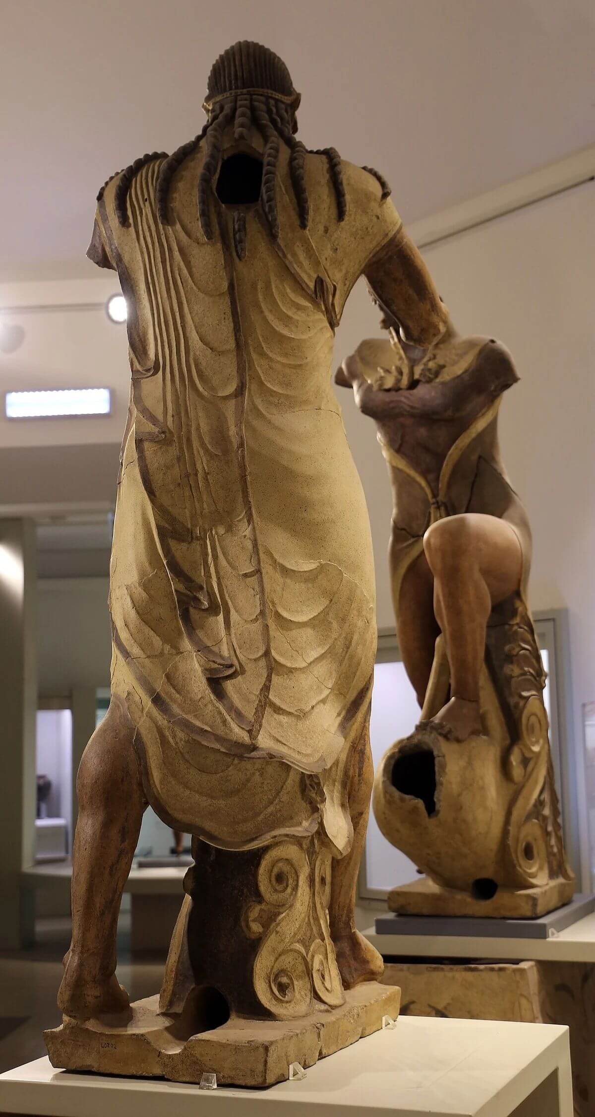 Apollo of Veii Etruscan terracotta statue, rear view showing braided hair and draped cloak