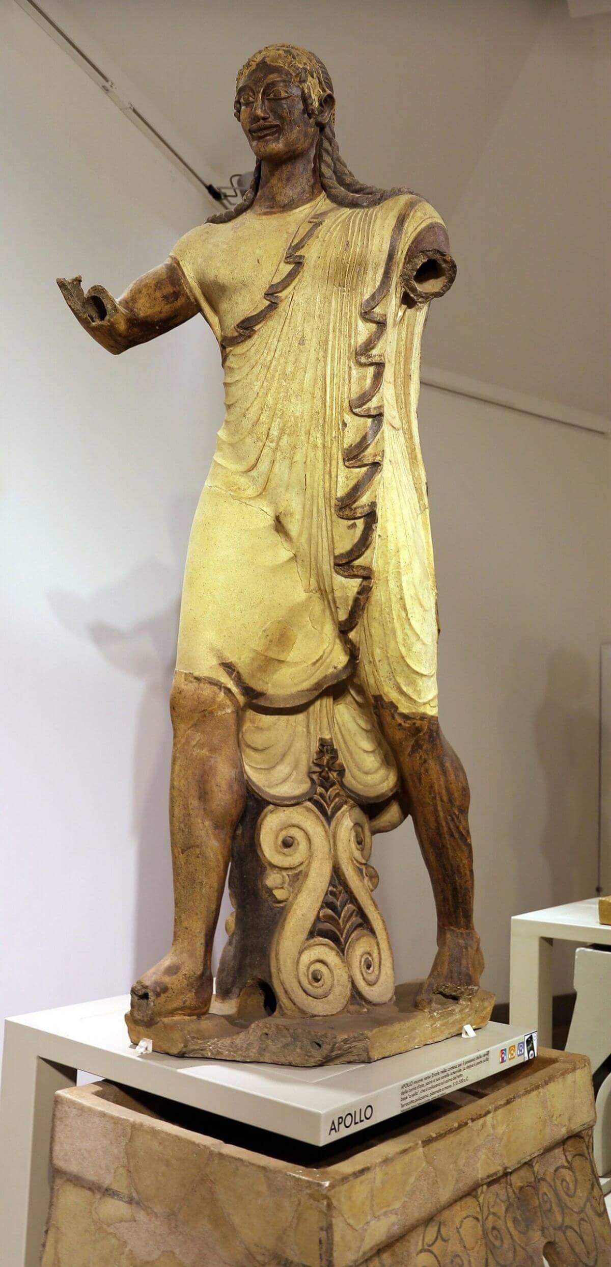 Front view of the Apollo of Veii, an Etruscan terracotta statue with a long braided hairstyle