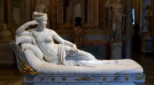Canova’s Paolina Borghese as Venus Victrix reclining with an apple on a marble couch at the Borghese Gallery.